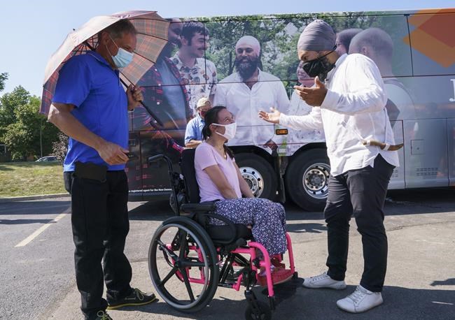 NDP leader Jagmeet Singh talks with a supporter during a campaign stop in Hamilton, Ont., on Tuesday, August 24, 2021. THE CANADIAN PRESS/Paul Chiasson