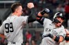 New York Yankees second baseman Rougned Odor (12) celebrates with Aaron Judge (99) after hitting a solo home run in the seventh inning of a baseball game against the Atlanta Braves Tuesday, Aug. 24, 2021, in Atlanta. (AP Photo/John Bazemore)