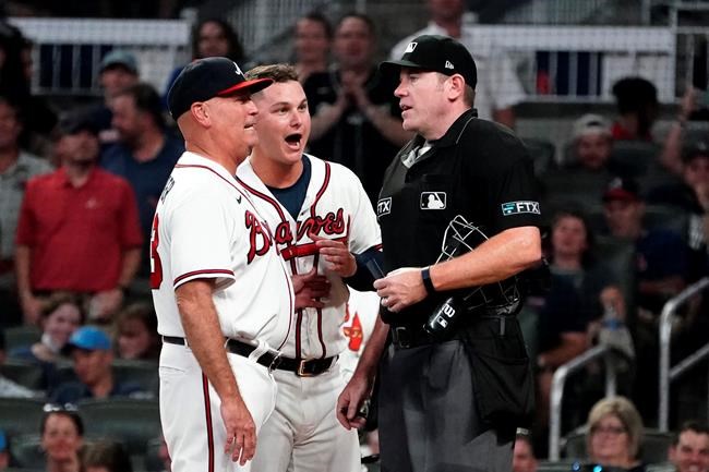 Atlanta Braves manager Brian Snitker (43), left, and Joc Pederson (22) argue with umpire umpire Chris Conroy (98) after Pederson was ejected in the fourth inning of a baseball game against the New York Yankees Tuesday, Aug. 24, 2021, in Atlanta. (AP Photo/John Bazemore)