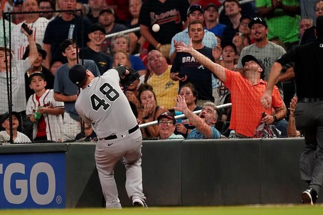 New York Yankees first baseman Anthony Rizzo (48) chases a foul ball from Atlanta Braves' Dansby Swanson in the sixth inning of a baseball game Tuesday, Aug. 24, 2021, in Atlanta. (AP Photo/John Bazemore)
