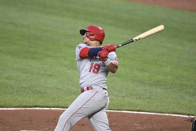 Los Angeles Angels' Juan Lagares (19) watches his two-run home run which scored Los Angeles Angels' Jo Adell hit against Baltimore Orioles starting pitcher Spenser Watkins during the second inning of a baseball game Tuesday, Aug. 24, 2021, in Baltimore. (AP Photo/Terrance Williams)