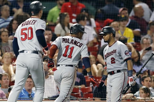 Minnesota Twins' Jorge Polanco (11) celebrates his two-run home run with Luis Arraez (2) that also drove in Brent Rooker (50) during the seventh inning of a baseball game against the Boston Red Sox, Tuesday, Aug. 24, 2021, in Boston. (AP Photo/Michael Dwyer)