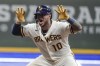 Milwaukee Brewers' Omar Narvaez reacts after hitting an RBI double during the seventh inning of a baseball game against the Cincinnati Reds Tuesday, Aug. 24, 2021, in Milwaukee. (AP Photo/Morry Gash)