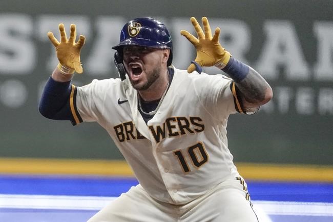 Milwaukee Brewers' Omar Narvaez reacts after hitting an RBI double during the seventh inning of a baseball game against the Cincinnati Reds Tuesday, Aug. 24, 2021, in Milwaukee. (AP Photo/Morry Gash)