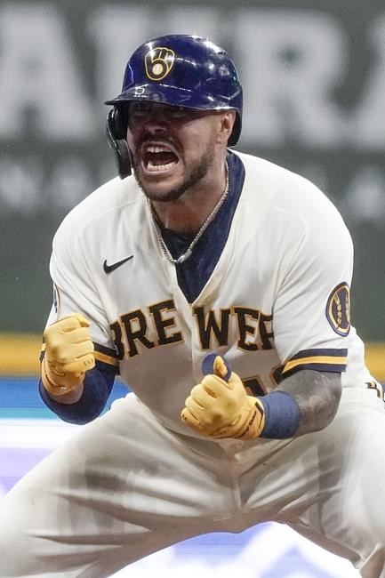 Milwaukee Brewers' Omar Narvaez reacts after hitting an RBI double during the seventh inning of a baseball game against the Cincinnati Reds Tuesday, Aug. 24, 2021, in Milwaukee. (AP Photo/Morry Gash)