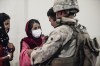 In this image provided by the U.S. Marine Corps, a Marine processes youth to be evacuated, at Hamid Karzai International Airport, Monday, Aug. 23. (Gunnery Sgt. Melissa Marnell/U.S. Marine Corps via AP)