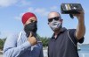NDP leader Jagmeet Singh stops for a photo with a supporter along the waterfront in Windsor, Ontario on Wednesday, August 25, 2021. THE CANADIAN PRESS/Paul Chiasson
