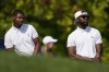 Earl Cooper, left, and Olajuwon Ajanaku, founders of Eastside Golf apparel, look on as Tony Finau tees off from the 13th hole during the ProAm at the BMW Championship golf tournament, Wednesday, Aug. 25, 2021, at Caves Valley Golf Club in Owings Mills, Md. The BMW Championship tournament begins Thursday. (AP Photo/Julio Cortez)