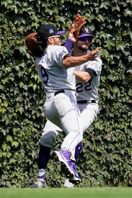 Colorado Rockies left fielder Connor Joe, left, and center fielder Sam Hilliard collide going after a fly ball hit by Chicago Cubs' Frank Schwindel during the first inning in the first baseball game of a doubleheader in Chicago, Wednesday, Aug. 25, 2021. (AP Photo/Nam Y. Huh)