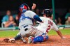 Cleveland Indians' Yu Chang, right, scores as Texas Rangers' Jose Trevino is late with the tag during the sixth inning of a baseball game Wednesday, Aug. 25, 2021, in Cleveland. (AP Photo/Tony Dejak)