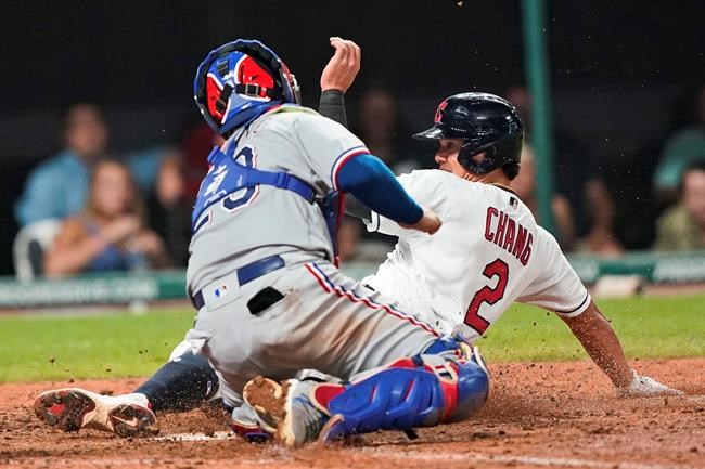 Cleveland Indians' Yu Chang, right, scores as Texas Rangers' Jose Trevino is late with the tag during the sixth inning of a baseball game Wednesday, Aug. 25, 2021, in Cleveland. (AP Photo/Tony Dejak)