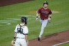 Arizona Diamondbacks' Josh VanMeter (19) runs home to score behind Pavin Smith as Pittsburgh Pirates catcher Jacob Stallings awaits a throw from left fielder Anthony Alford on the double by Diamondback's David Peralta in the eighth inning of a baseball game, Wednesday, Aug. 25, 2021, in Pittsburgh. (AP Photo/Keith Srakocic)