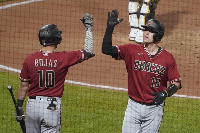 Arizona Diamondbacks' Carson Kelly (18) is greeted by Josh Rojas after hitting a solo home run against the Pittsburgh Pirates during the seventh inning of a baseball game, Wednesday, Aug. 25, 2021, in Pittsburgh. (AP Photo/Keith Srakocic)