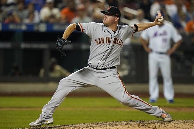 San Francisco Giants' Jake McGee delivers a pitch during the ninth inning of a baseball game against the New York Mets Wednesday, Aug. 25, 2021, in New York. The Giants won 3-2. (AP Photo/Frank Franklin II)