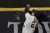 Milwaukee Brewers' Avisail Garcia catches a long fly ball hit by Cincinnati Reds' Max Schrock during the eighth inning of a baseball game Wednesday, Aug. 25, 2021, in Milwaukee. (AP Photo/Morry Gash)
