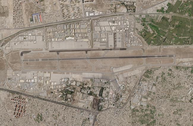 In this satellite photo released by Planet Labs Inc., Kabul's international airport is seen as an evacuation flight taxis to the military side of the airport in Kabul, Afghanistan, Thursday, Aug. 26, 2021. Western nations warned Thursday of a possible attack on the airport, where thousands have flocked as they try to flee Taliban-controlled Afghanistan in the waning days of a massive airlift. (Planet Labs Inc. via AP)