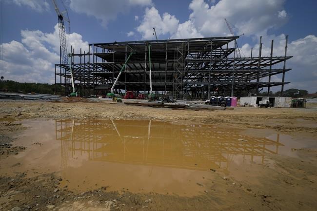 Construction personnel work on Carolina Panthers' state-of-the-art team headquarters and practice facility Tuesday, Aug. 24, 2021, in Rock Hill, S.C.