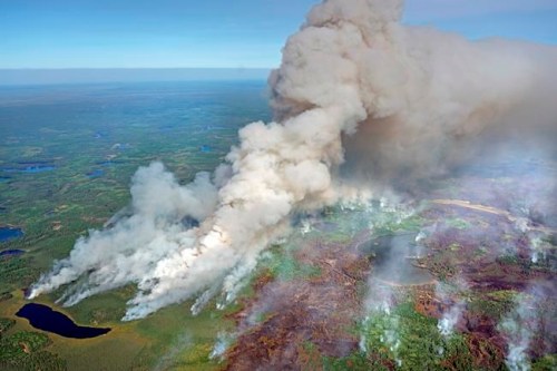 As the Greenwood Fire continues to burn, smoke from the blaze fills the air near Pitcha Lake (bottom left) as fire crews set back fires to better control the perimeter, Wednesday, Aug. 25, 2021, in Isabella, Minn. (Brian Peterson/Star Tribune via AP)