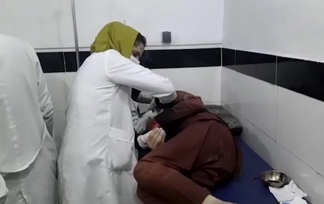 In this frame grab from video, a medical worker attends to a person wounded in a deadly explosion at the Kabul airport, at a hospital in Kabul, Afghanistan, Thursday, Aug. 26, 2021. Two suicide bombers and gunmen have targeted crowds massing near the Kabul airport, in the waning days of a massive airlift that has drawn thousands of people seeking to flee the Taliban takeover of Afghanistan. (AP Photo)