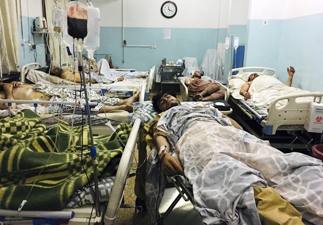 Wounded Afghans lie on a bed at a hospital after a deadly explosion outside the airport in Kabul, Afghanistan, Thursday, Aug. 26, 2021. Two suicide bombers and gunmen attacked crowds of Afghans flocking to Kabul's airport Thursday, transforming a scene of desperation into one of horror in the waning days of an airlift for those fleeing the Taliban takeover. (AP Photo/Mohammad Asif Khan)