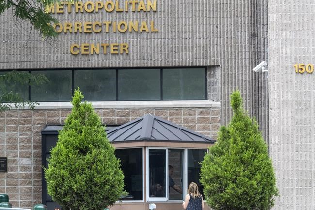 FILE - In this Aug. 13, 2019 file photo, an employee checks a visitor outside the Metropolitan Correctional Center in New York. Federal officials said Thursday, Aug. 26, 2021, they are shutting down the embattled jail in New York City after a slew of problems that came to light following Jeffrey Epstein’s suicide there two years ago. (AP Photo/Mary Altaffer, File)
