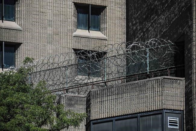 FILE - This Aug. 10, 2019, shows razor wire fencing at the Metropolitan Correctional Center in New York. The U.S. government said Thursday, Aug. 26, 2021, it is shutting down the embattled federal jail in New York City after a slew of problems that came to light following Jeffrey Epstein’s suicide there two years ago. (AP Photo/Bebeto Matthews, File)