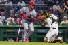 Pittsburgh Pirates catcher Michael Perez, right, looks for the ball after St. Louis Cardinals' Edmundo Sosa was hit by a pitch from Mitch Keller during the sixth inning of a baseball game Thursday, Aug. 26, 2021, in Pittsburgh. (AP Photo/Keith Srakocic)