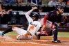 Miami Marlins' Lewis Brinson scores on a single by Brian Anderson as Washington Nationals catcher Tres Barrera waits for the throw during the first inning of a baseball game Thursday, Aug. 26, 2021, in Miami. (AP Photo/Wilfredo Lee)