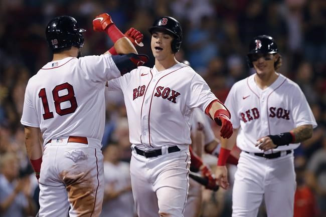 Boston Red Sox's Bobby Dalbec, center, celebrates with Kyle Schwarber (18) after hitting a two-run home run that scored Jarren Duran, right, during the seventh inning of the team's baseball game against the Minnesota Twins, Thursday, Aug. 26, 2021, in Boston. (AP Photo/Michael Dwyer)