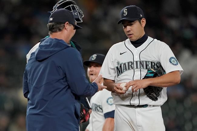 Seattle Mariners starting pitcher Yusei Kikuchi is pulled from the baseball game against the Kansas City Royals by manager Scott Servais, left, during the sixth inning Thursday, Aug. 26, 2021, in Seattle. (AP Photo/Ted S. Warren)