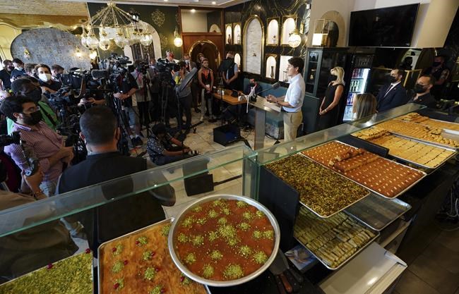 More than 45 Liberal staff, restaurant staff, media, restaurant owners and technicians crowd into a small restaurant as Liberal Leader Justin Trudeau makes a campaign stop in Mississauga, Ont., on Friday, Aug. 27, 2021. THE CANADIAN PRESS/Sean Kilpatrick