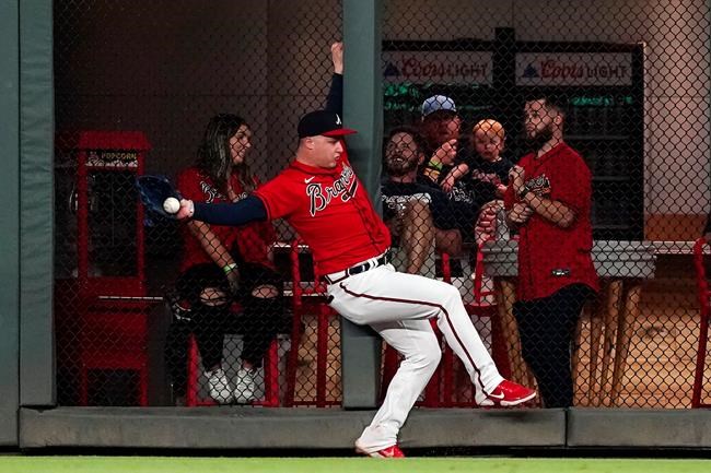 Atlanta Braves right fielder Joc Pederson catches a fly ball from San Francisco Giants' Tommy La Stella at the wall for the final out of a baseball game Friday, Aug. 27, 2021, in Atlanta. (AP Photo/John Bazemore)