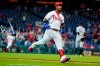 Philadelphia Phillies' Jean Segura celebrates after hitting a game-winning RBI-single off Arizona Diamondbacks pitcher Taylor Clarke during the 11th inning of a baseball game, Friday, Aug. 27, 2021, in Philadelphia. (AP Photo/Matt Slocum)