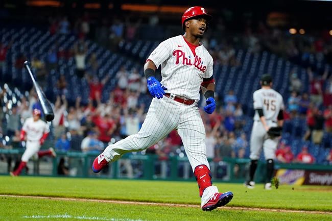 Philadelphia Phillies' Jean Segura celebrates after hitting a game-winning RBI-single off Arizona Diamondbacks pitcher Taylor Clarke during the 11th inning of a baseball game, Friday, Aug. 27, 2021, in Philadelphia. (AP Photo/Matt Slocum)