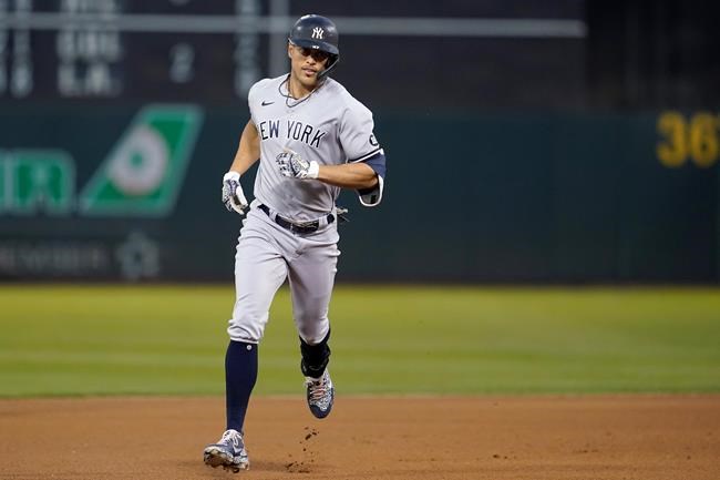New York Yankees' Giancarlo Stanton rounds the bases after hitting a home run against the Oakland Athletics during the fourth inning of a baseball game in Oakland, Calif., Friday, Aug. 27, 2021. (AP Photo/Jeff Chiu)
