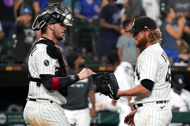 Chicago White Sox catcher Yasmani Grandal, left, celebrates with relief pitcher Craig Kimbrel after the White Sox defeated the Chicago Cubs 17-13 in a baseball game in Chicago, Friday, Aug. 27, 2021. (AP Photo/Nam Y. Huh)