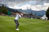Matthew Jordan of England chips the ball onto the green in the stadium at hole 18 during the third round of the Omega European Masters Golf Tournament in Crans-Montana, Switzerland, Saturday, Aug. 28, 2021. (Peter Klaunzer/Keystone via AP)