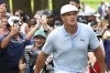 Spectators run up behind Bryson DeChambeau after he shot from the rough on the eighth hole during the third round of the BMW Championship golf tournament, Saturday, Aug. 28, 2021, at Caves Valley Golf Club in Owings Mills, Md. (AP Photo/Terrance Williams)