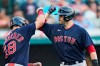 Boston Red Sox's J.D. Martinez, right, celebrates with Kyle Schwarber after hitting a three-run home run in the 10th inning of a baseball game against the Cleveland Indians, Saturday, Aug. 28, 2021, in Cleveland. (AP Photo/Tony Dejak)