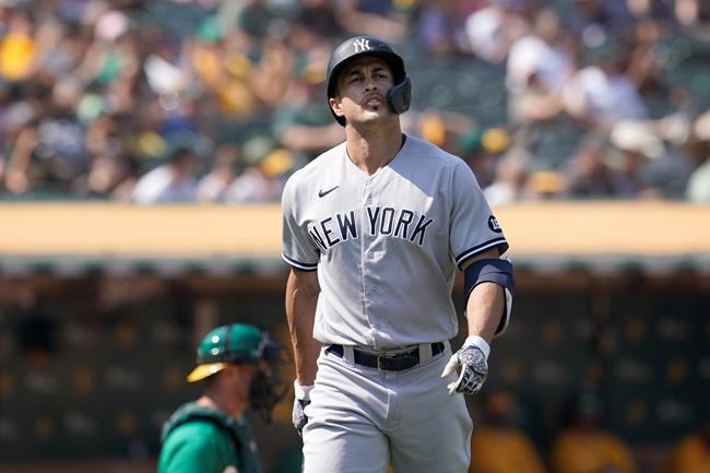 New York Yankees' Giancarlo Stanton walks to the dugout after striking out against the Oakland Athletics during the seventh inning of a baseball game in Oakland, Calif., Saturday, Aug. 28, 2021. (AP Photo/Jeff Chiu)