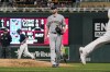 Milwaukee Brewers pitcher Adrian Houser, center, walks off the mound as Minnesota Twins' Brent Rooker, right, heads home on a bases-loaded walk off Houser of Twins' Luis Arraez as Andrelton Simmons, second from back left, heads to second base in the fourth inning of a baseball game Saturday, Aug. 28, 2021, in Minneapolis. (AP Photo/Jim Mone)