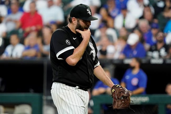 Chicago White Sox starting pitcher Lance Lynn wipes his face as he walks to the dugout during the fourth inning of a baseball game against the Chicago Cubs in Chicago, Saturday, Aug. 28, 2021. (AP Photo/Nam Y. Huh)
