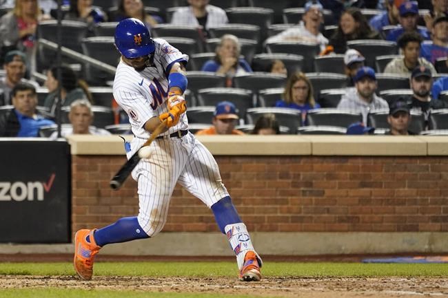 New York Mets' Francisco Lindor hits a single during the sixth inning of the team's baseball game against the Washington Nationals, Saturday, Aug. 28, 2021, in New York. (AP Photo/Mary Altaffer)