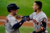 Houston Astros' Alex Bregman (2) and Carlos Correa, right, celebrate Correa's solo home run in the third inning of a baseball game against the Texas Rangers in Arlington, Texas, Saturday, Aug. 28, 2021. (AP Photo/Tony Gutierrez)