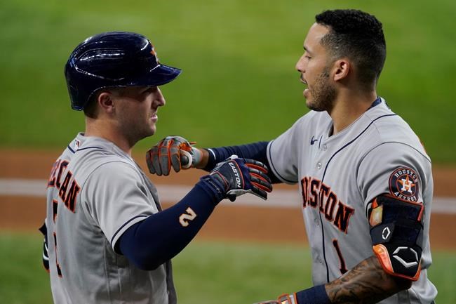Houston Astros' Alex Bregman (2) and Carlos Correa, right, celebrate Correa's solo home run in the third inning of a baseball game against the Texas Rangers in Arlington, Texas, Saturday, Aug. 28, 2021. (AP Photo/Tony Gutierrez)