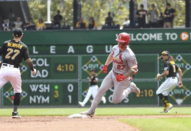 St. Louis Cardinals' Tyler O'Neill (27) rounds second base and passes Pittsburgh Pirates shortstop Kevin Newman, left, while getting a triple in the third inning during a baseball game Sunday, Aug. 29, 2021, in Pittsburgh. (AP Photo/Philip G. Pavely)