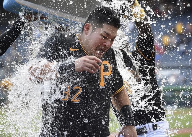 Pittsburgh Pirates' Yoshi Tsutsugo is doused after he hit a three-run winning walkoff home run in the ninth inning against the St. Louis Cardinals in a baseball game Sunday, Aug. 29, 2021, in Pittsburgh. (AP Photo/Philip G. Pavely)