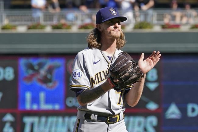 Milwaukee Brewers relief pitcher Josh Hader applauds after striking out Minnesota Twins' Ryan Jeffers in the ninth inning to end the baseball game, Sunday, Aug. 29, 2021, in Minneapolis. (AP Photo/Jim Mone)