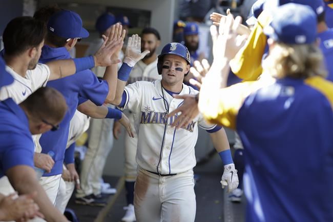Seattle Mariners' Jarred Kelenic celebrates in the dugout after hitting a solo home run during the sixth inning of a baseball game against the Kansas City Royals, Sunday, Aug. 29, 2021, in Seattle. (AP Photo/Jason Redmond)