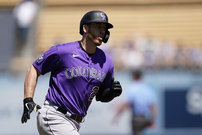 Colorado Rockies C.J. Cron (25) runs the bases after hitting a home run during the first inning of a baseball game against the Los Angeles Dodgers Sunday, Aug. 29, 2021, in Los Angeles. Brendan Rodgers and Charlie Blackman also scored. (AP Photo/Ashley Landis)